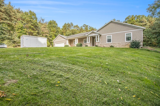 ranch-style house featuring a garage and a front yard