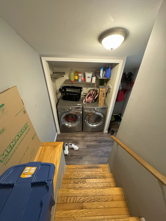 laundry room with separate washer and dryer and hardwood / wood-style flooring