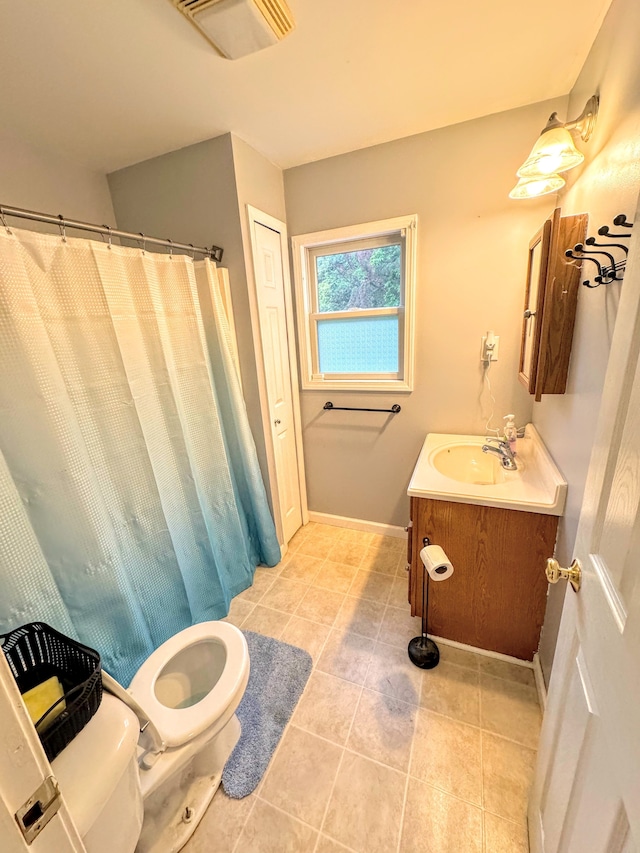 bathroom with tile patterned floors, vanity, and toilet