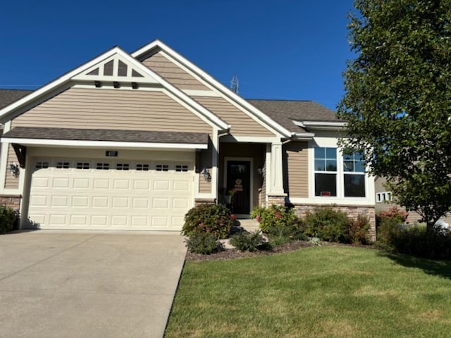 craftsman inspired home featuring a front yard and a garage