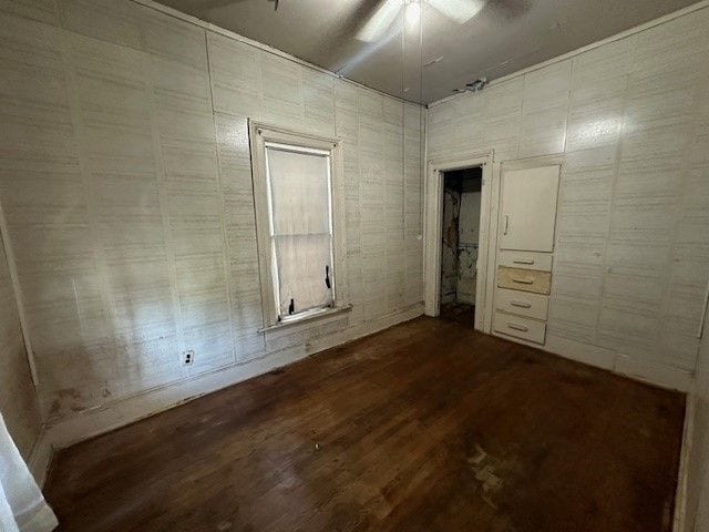 unfurnished bedroom featuring hardwood / wood-style floors and ceiling fan