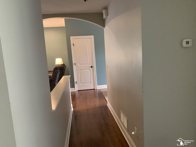 hallway with dark hardwood / wood-style flooring