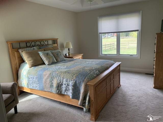 carpeted bedroom with ceiling fan