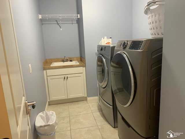 clothes washing area with cabinets, independent washer and dryer, light tile patterned floors, and sink