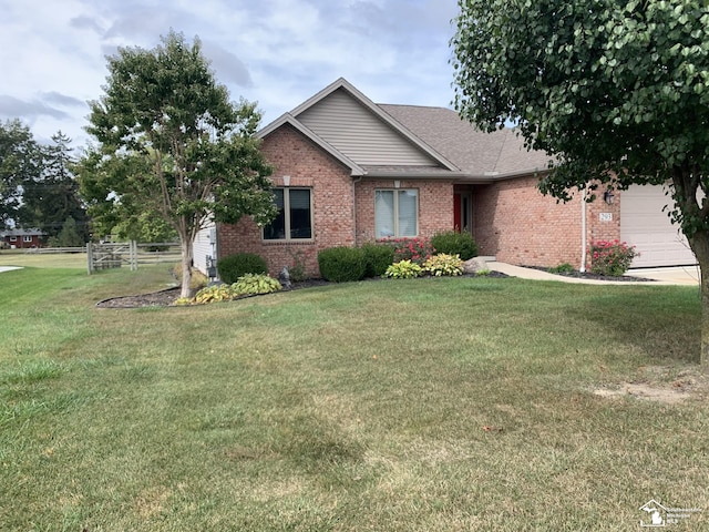 view of front of property with a garage and a front yard