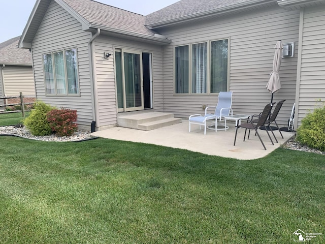 rear view of property with a patio area and a lawn