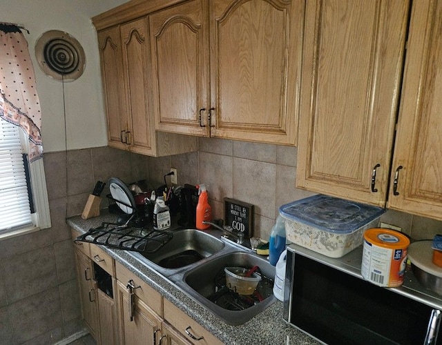 kitchen featuring a sink and decorative backsplash