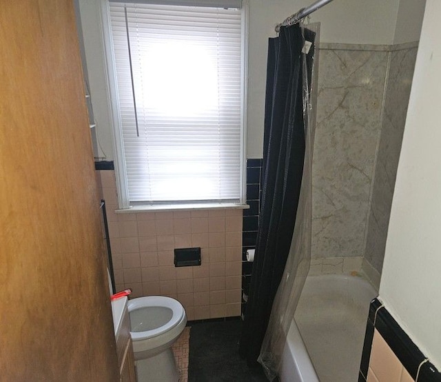 full bathroom with toilet, curtained shower, and tile walls