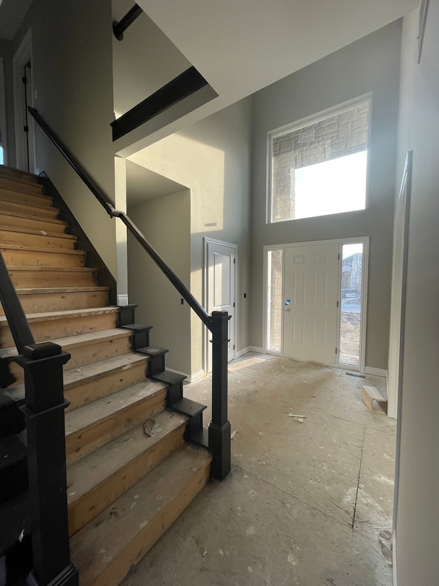 entrance foyer featuring stairway and a high ceiling