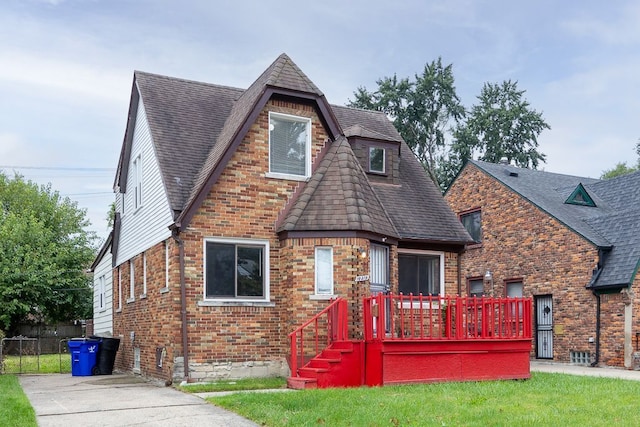 tudor-style house with a front lawn