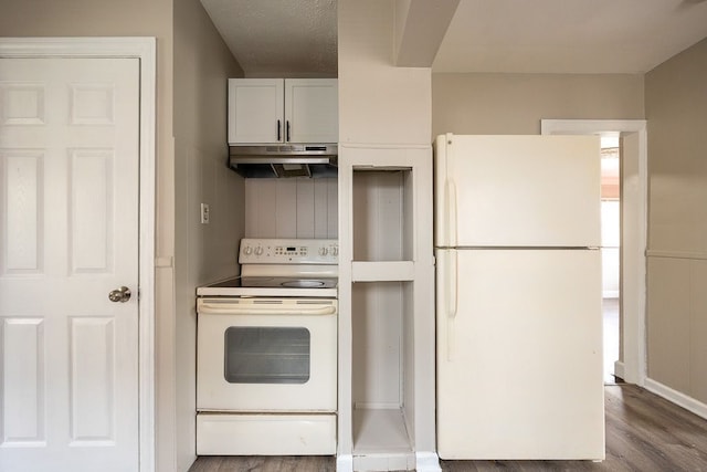 kitchen with hardwood / wood-style flooring, white cabinetry, white appliances, and a textured ceiling