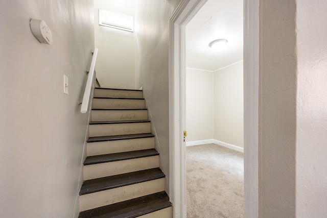 staircase featuring carpet floors and ornamental molding