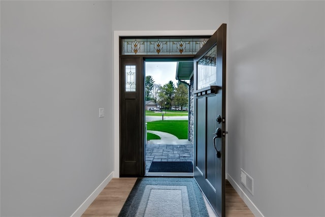 entryway with hardwood / wood-style flooring