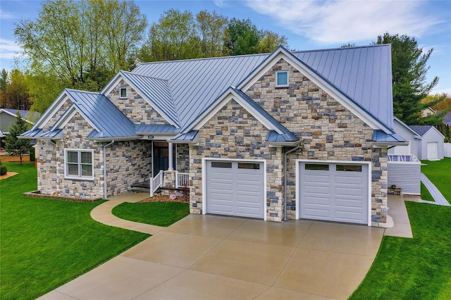 craftsman house featuring a garage and a front lawn