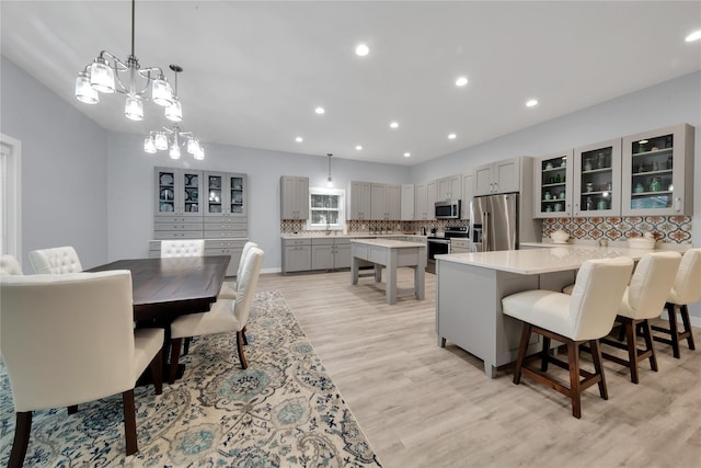 dining room with an inviting chandelier and light hardwood / wood-style flooring