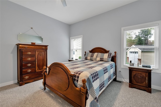 bedroom with light colored carpet and ceiling fan