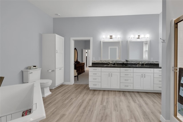 bathroom featuring hardwood / wood-style floors, vanity, and toilet