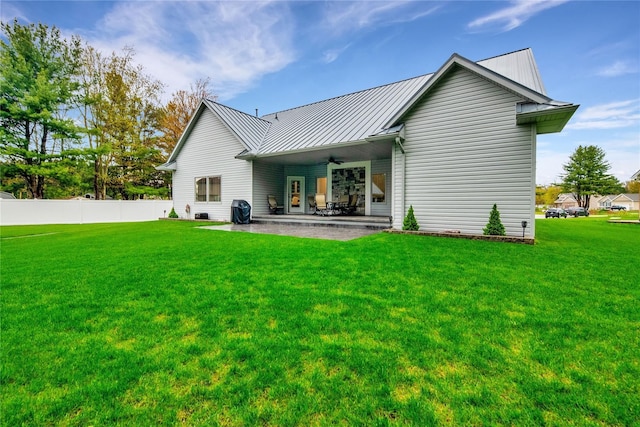 back of property featuring a patio, ceiling fan, and a lawn