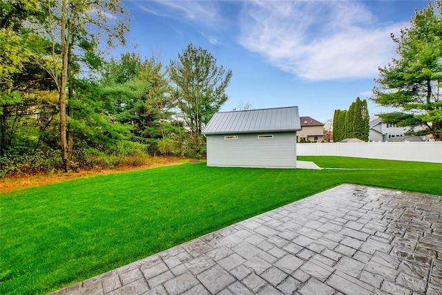 view of yard with an outbuilding and a patio