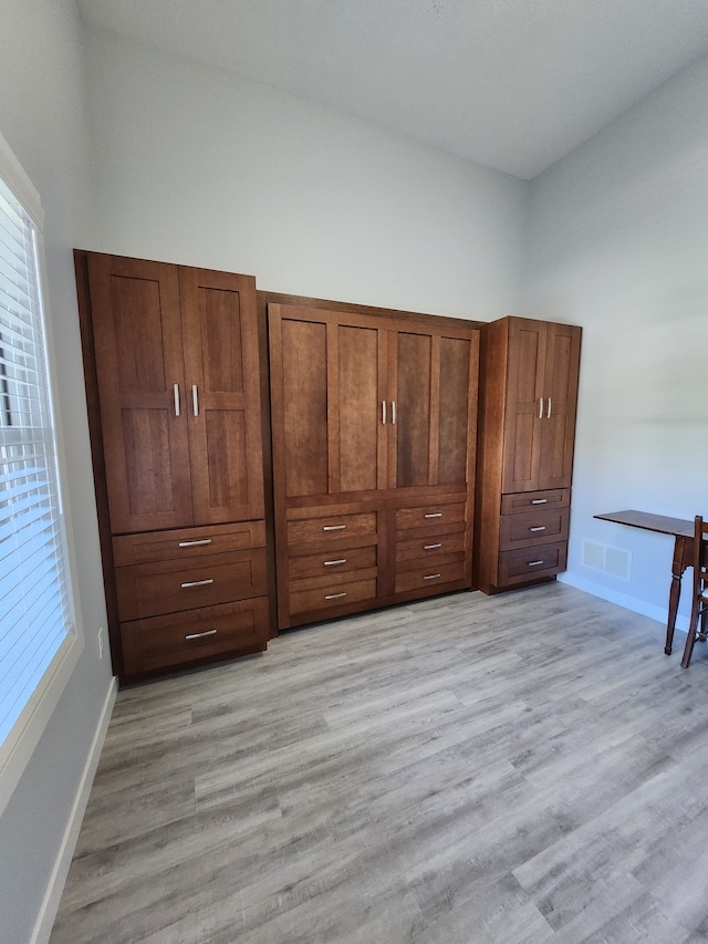 unfurnished bedroom with light wood-type flooring