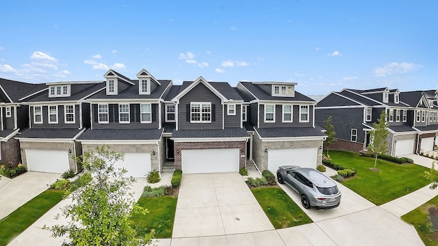 townhome / multi-family property featuring a front yard and a garage