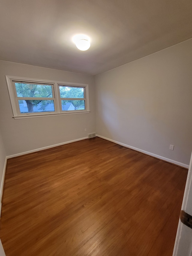 spare room with hardwood / wood-style flooring