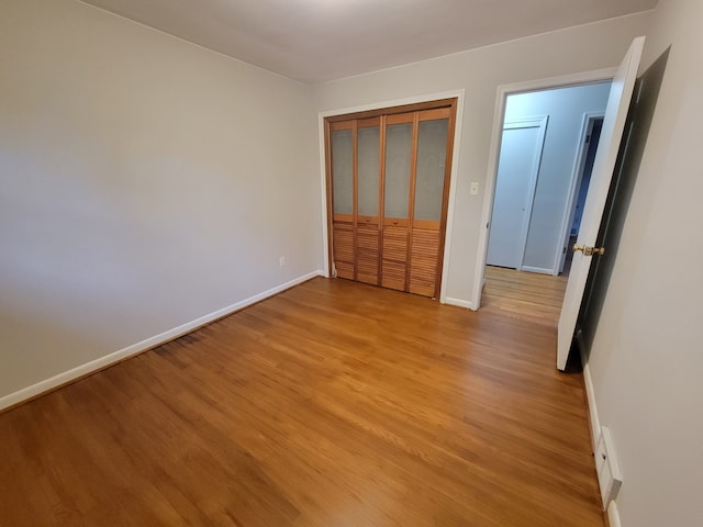 unfurnished bedroom featuring a closet and light hardwood / wood-style flooring