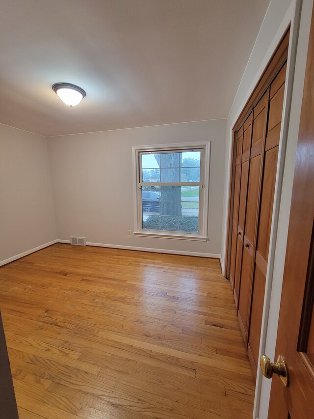 31990 Nottingwood St, Farmington Hills, MI 48334 - unfurnished bedroom with light wood-style flooring, baseboards, and a closet