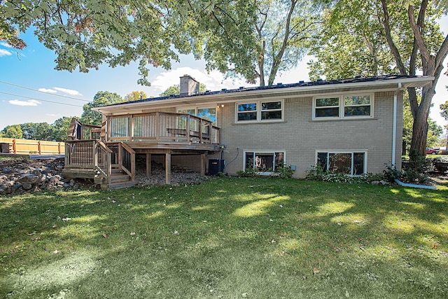 rear view of property with central AC, a yard, and a deck