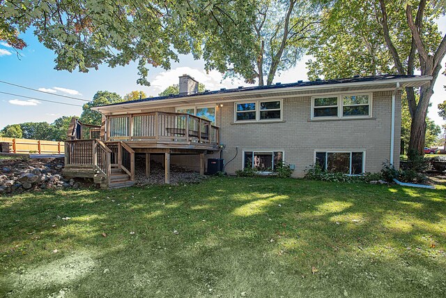31990 Nottingwood St, Farmington Hills, MI 48334 - rear view of property with a chimney, brick siding, a lawn, and a deck