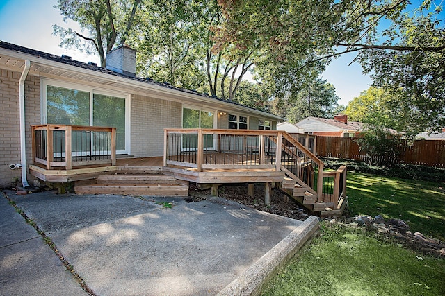 back of house featuring a yard, a patio, and a wooden deck