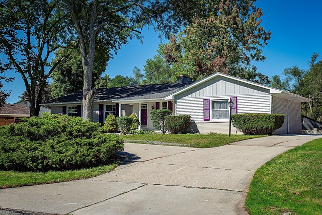 31990 Nottingwood St, Farmington Hills, MI 48334 - ranch-style home with concrete driveway, brick siding, and a front yard