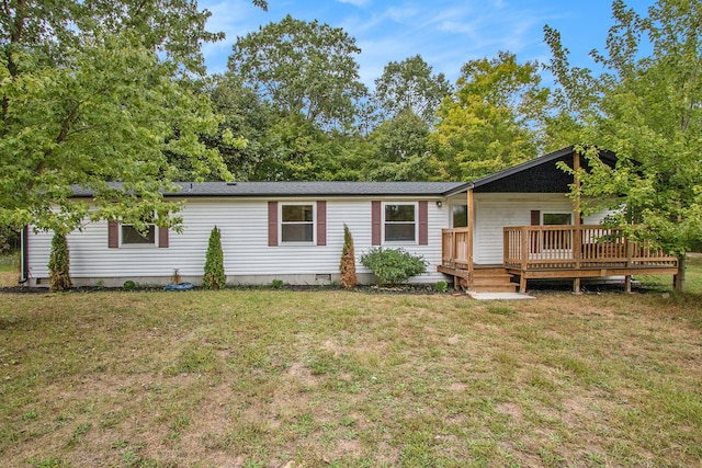 view of front of house featuring a front yard and a deck