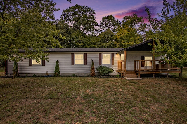 view of front of house with a lawn and a deck