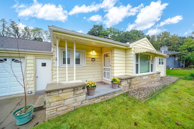 view of front of property with a front yard and a garage