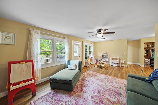 living room featuring hardwood / wood-style flooring and ceiling fan