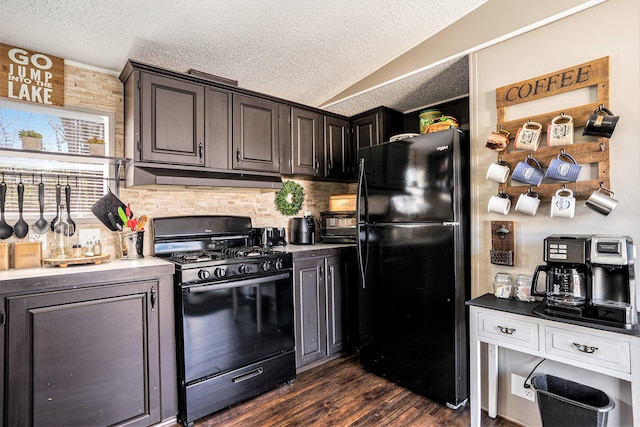 kitchen with dark brown cabinetry, dark hardwood / wood-style flooring, a textured ceiling, vaulted ceiling, and black appliances