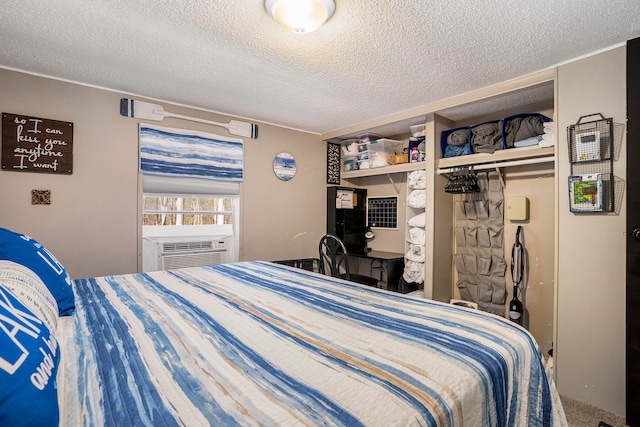 bedroom with a closet, cooling unit, and a textured ceiling