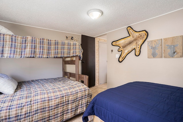 bedroom featuring light carpet and a textured ceiling