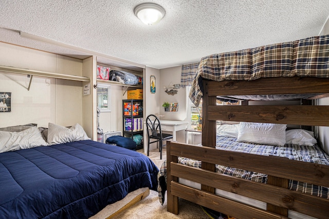 bedroom with carpet flooring and a textured ceiling