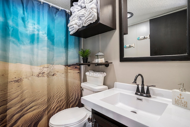 bathroom with vanity, a textured ceiling, and toilet