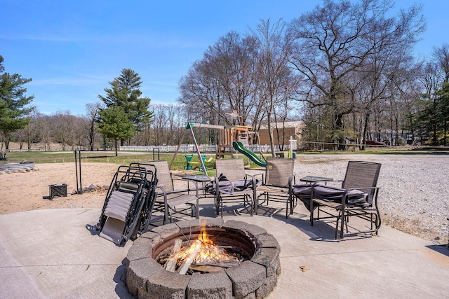 view of patio with a fire pit and a playground