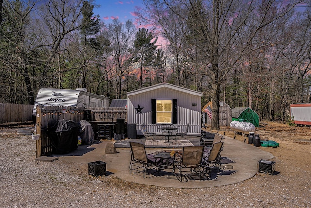 patio terrace at dusk with a shed