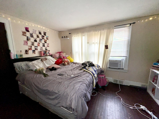 bedroom with dark hardwood / wood-style floors and cooling unit