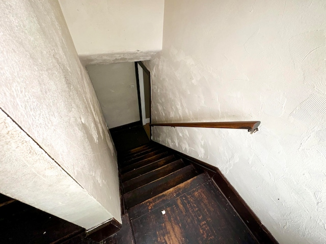 staircase with hardwood / wood-style floors