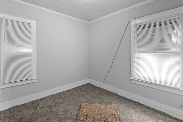 empty room with dark carpet and ornamental molding