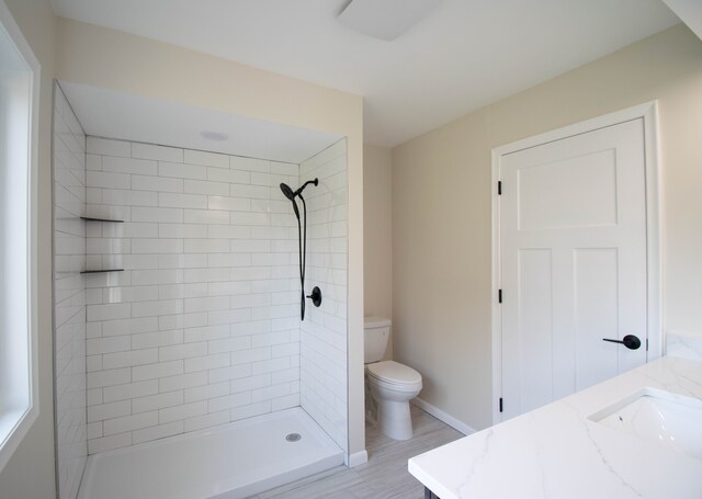 58085 Dulwich, Washington, MI 48094 - full bath with toilet, vanity, a tile shower, wood finished floors, and baseboards