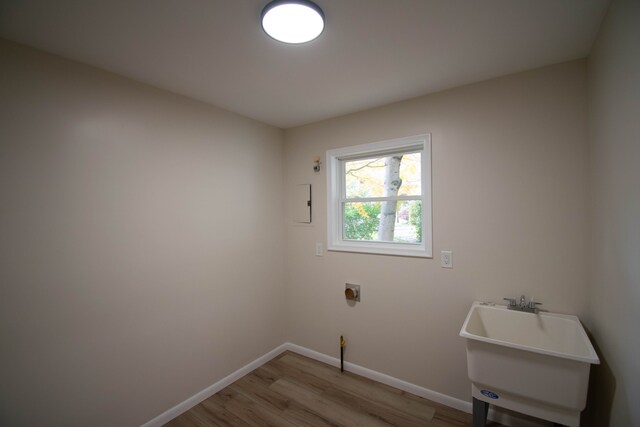 58085 Dulwich, Washington, MI 48094 - washroom with light wood-type flooring, baseboards, and electric dryer hookup