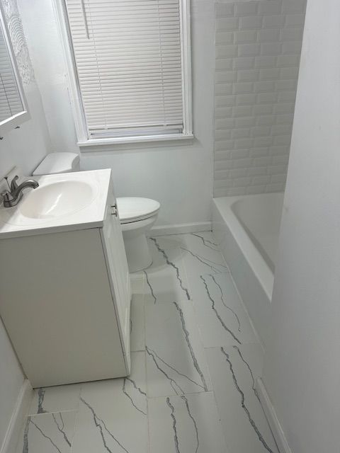 full bathroom with vanity, shower with separate bathtub, and toilet