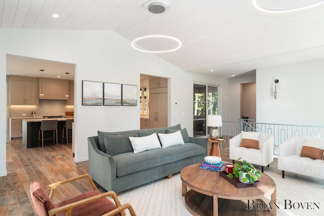 living room with light hardwood / wood-style floors, wood ceiling, and vaulted ceiling